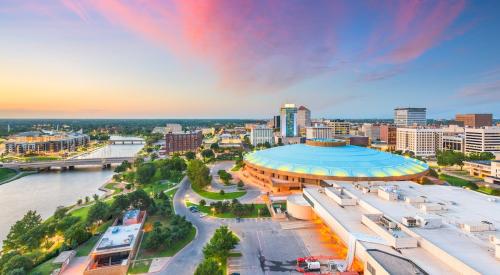 Wichita, KS aerial view with blue and pink wispy clouds 