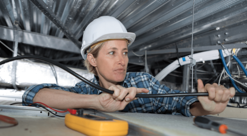 Woman electrician at work on jobsite