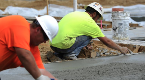 Workers trowel concrete house footing-photo hurlburt.af.mil 