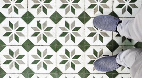 Patterned tile floor with person standing on it