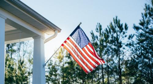 American flag on porch outside of house