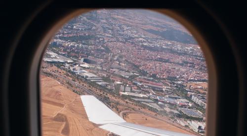 Looking out airplane window to land below