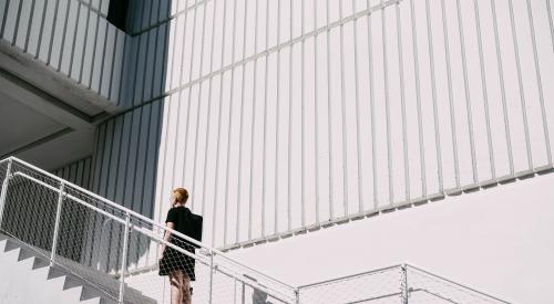 Woman climbing cement steps