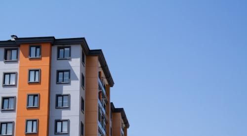 Exterior of orange and white multifamily apartment building