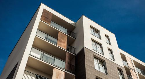 Exterior of white and tan apartment building