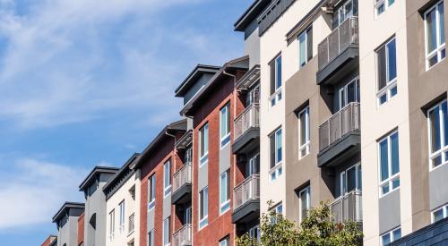 Row of connected colorful apartment buildings