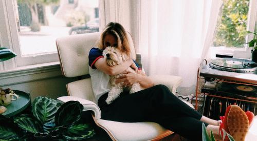 Woman at home in chair with pet