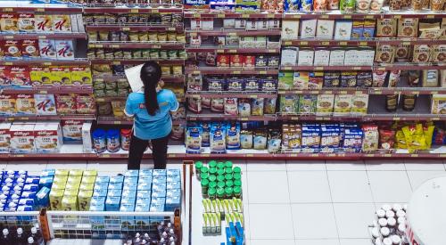 Worker taking inventory in grocery store