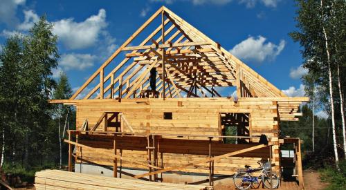 Bike outside of wood-framed house under construction