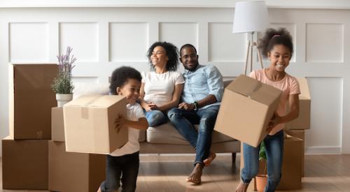 family unpacking boxes in new home