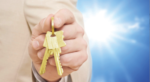 Hand holding keys to a new home