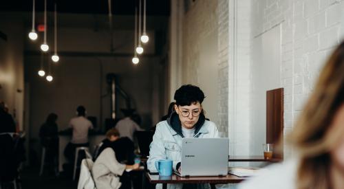 Person in coffeeshop working remotely