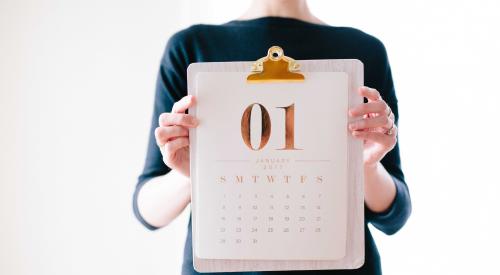 Woman holding up January 2019 calendar