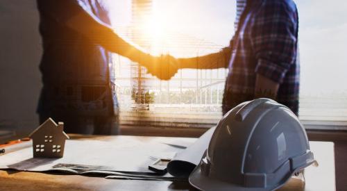 Home builder shaking client's hand after selling a new home