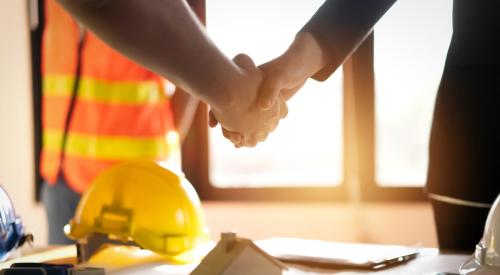 Builder and client shaking hands