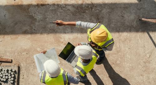 Builders using computer on job site and exploring the potential of AI in construction