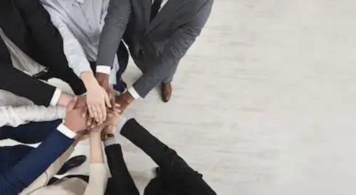 people with hands in circle show corporate diversity and teamwork 