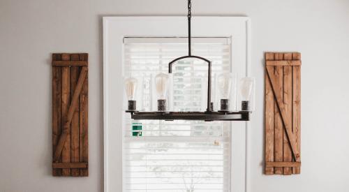 House interior with kitchen table and window with chandelier