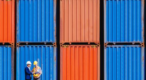 Workers in front of cargo storage