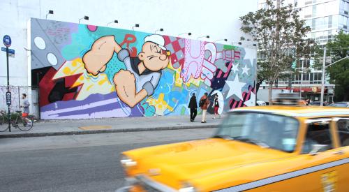 Checker cab in NYC in front of mural