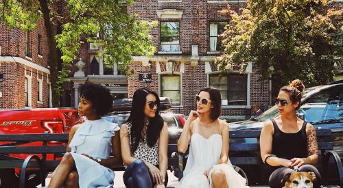 Women happy together on a bench