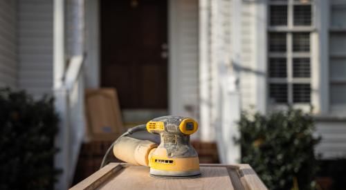 Power sander on a cabinet front outside of home