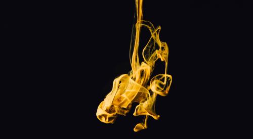 Yellow smoke against black background