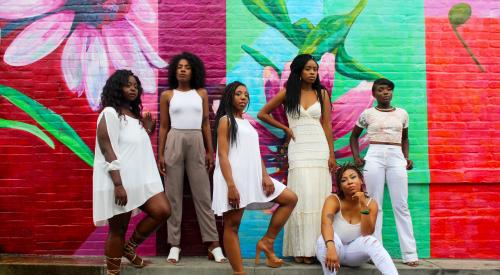 Women standing in front of mural in Minneapolis