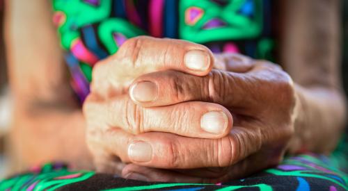 Woman with folded hands in lap