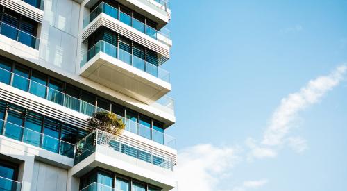 High-rise condo building with blue sky background