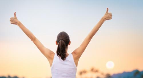 Confident woman with thumbs up 