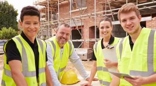 Construction apprentices at a jobsite learning home building skills