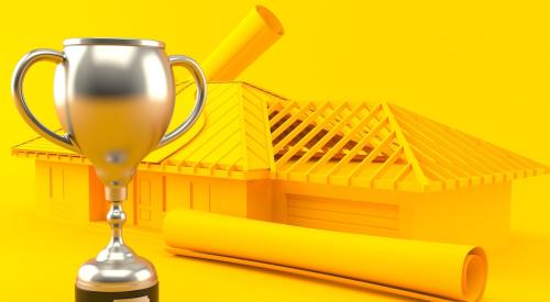 Trophy next to framed house and floor plans against bright yellow background