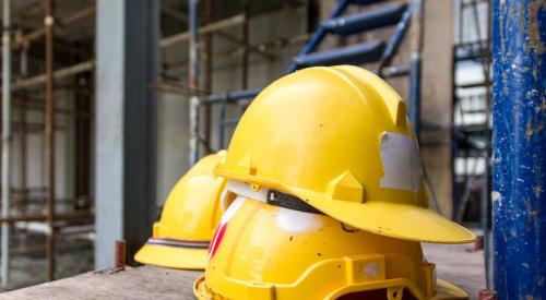 Yellow construction hard hats stacked 