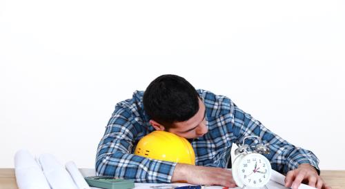 Construction work napping at desk