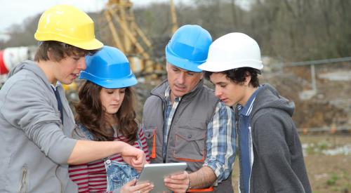 Construction students and instructor on job site of master planned community