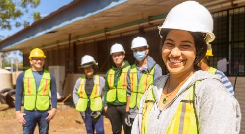 Construction students in vests and hard hats