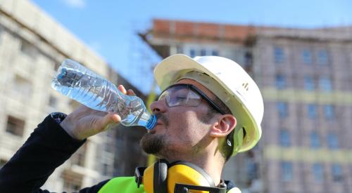 Construction worker drinking water