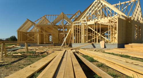 Home construction site with lumber ready for framing