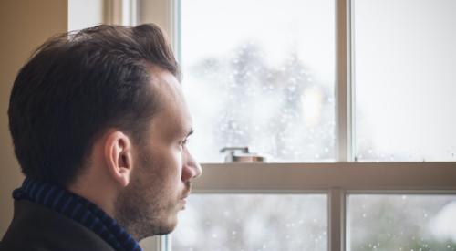 Consumer confidence looking out the window on a gloomy day