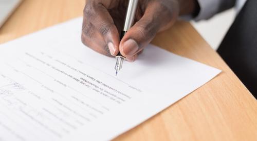 hand_holding_pen_signing_paper