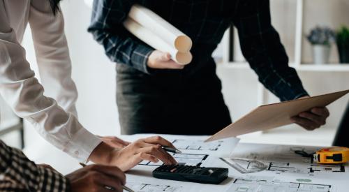 Contractors looking at plans on desk