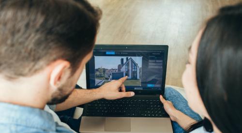 Couple looking at buying a home virtually on laptop