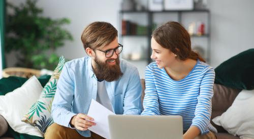 Couple looking over bills on couch