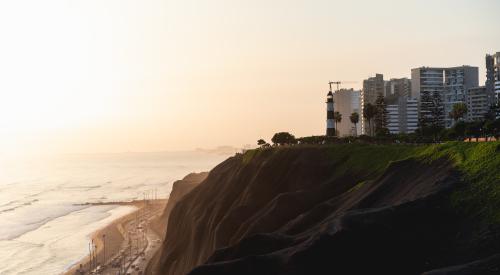 Housing by the water with a road at sunrise