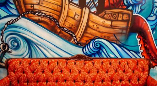 Sofa in front of mural