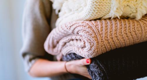 Woman carrying folded laundry