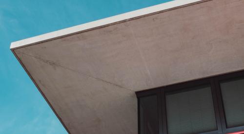 Low-angle shot of home exterior with pink and concrete accents