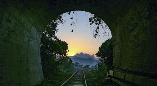 Daybreak at end of dark tunnel signaling a new beginning