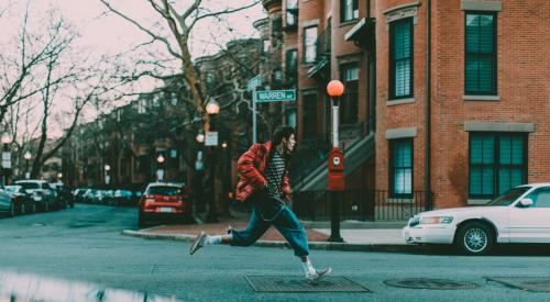 Man running down middle of street in Boston, Mass.